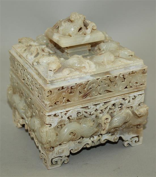 A Chinese archaistic burnt white and russet jade seal box and cover, width 12cm, height 14cm, wood stand